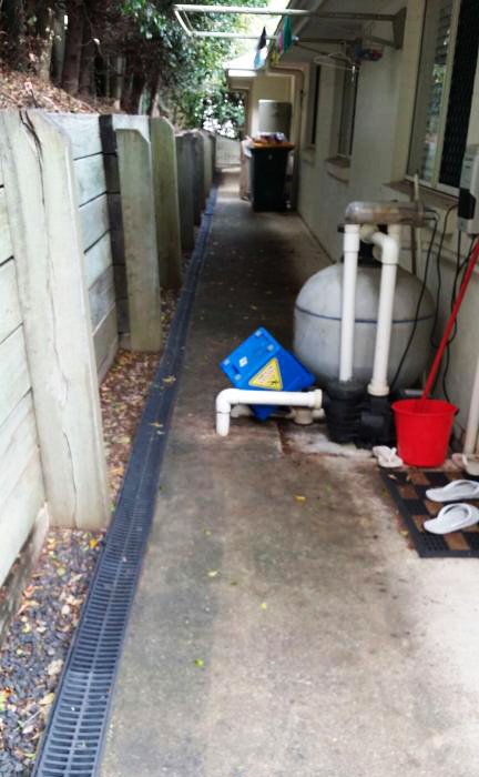 Paving in a side passage before being cleaned