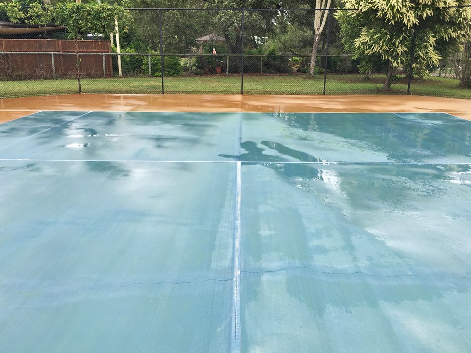 Wet tennis court after a professional clean