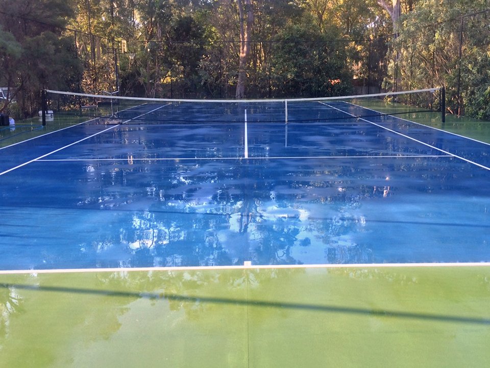 wet tennis court after being professionally cleaned
