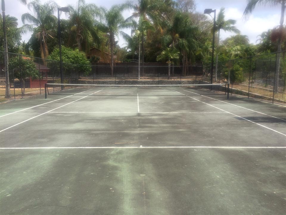 Tennis court before pressure cleaning