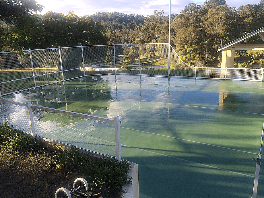 Wet tennis court after professional cleaning