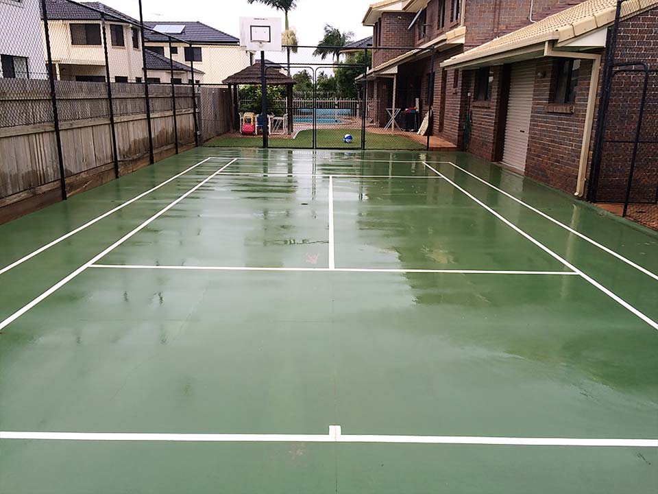 Wet tennis court after being professionally cleaned