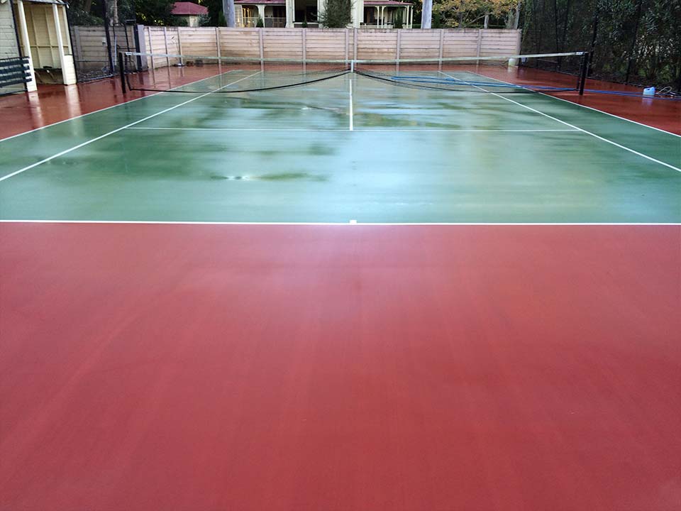 Wet tennis court after being professionally cleaned