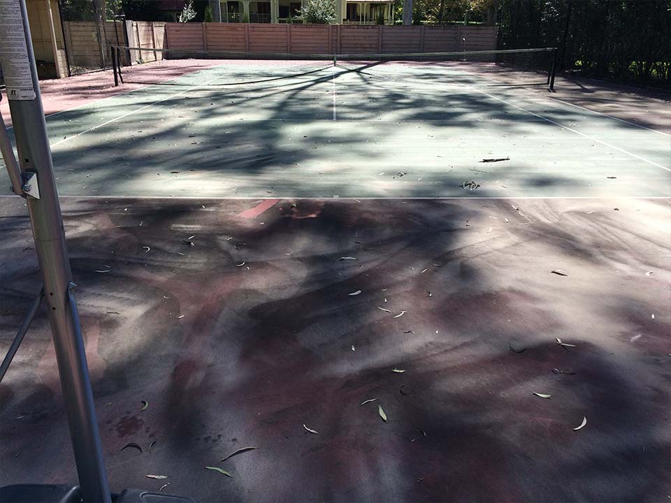 Dirty tennis court before being professionally cleaned