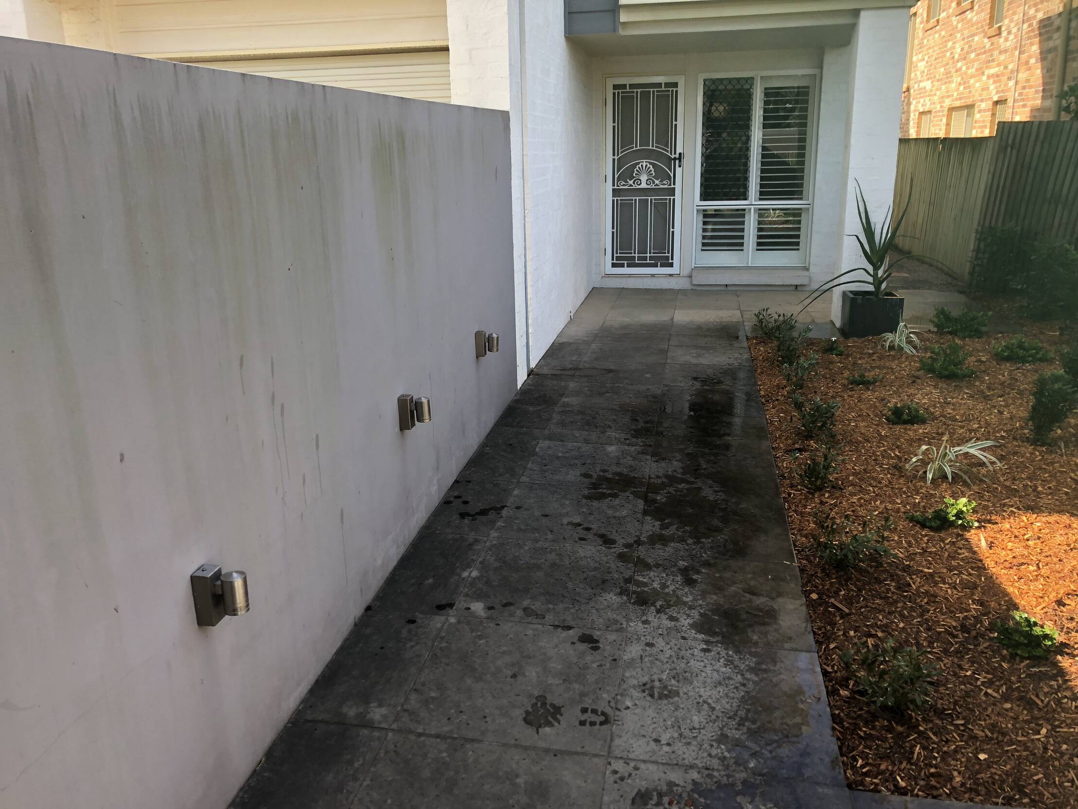 Dirty pathway leading to the front door of a property
