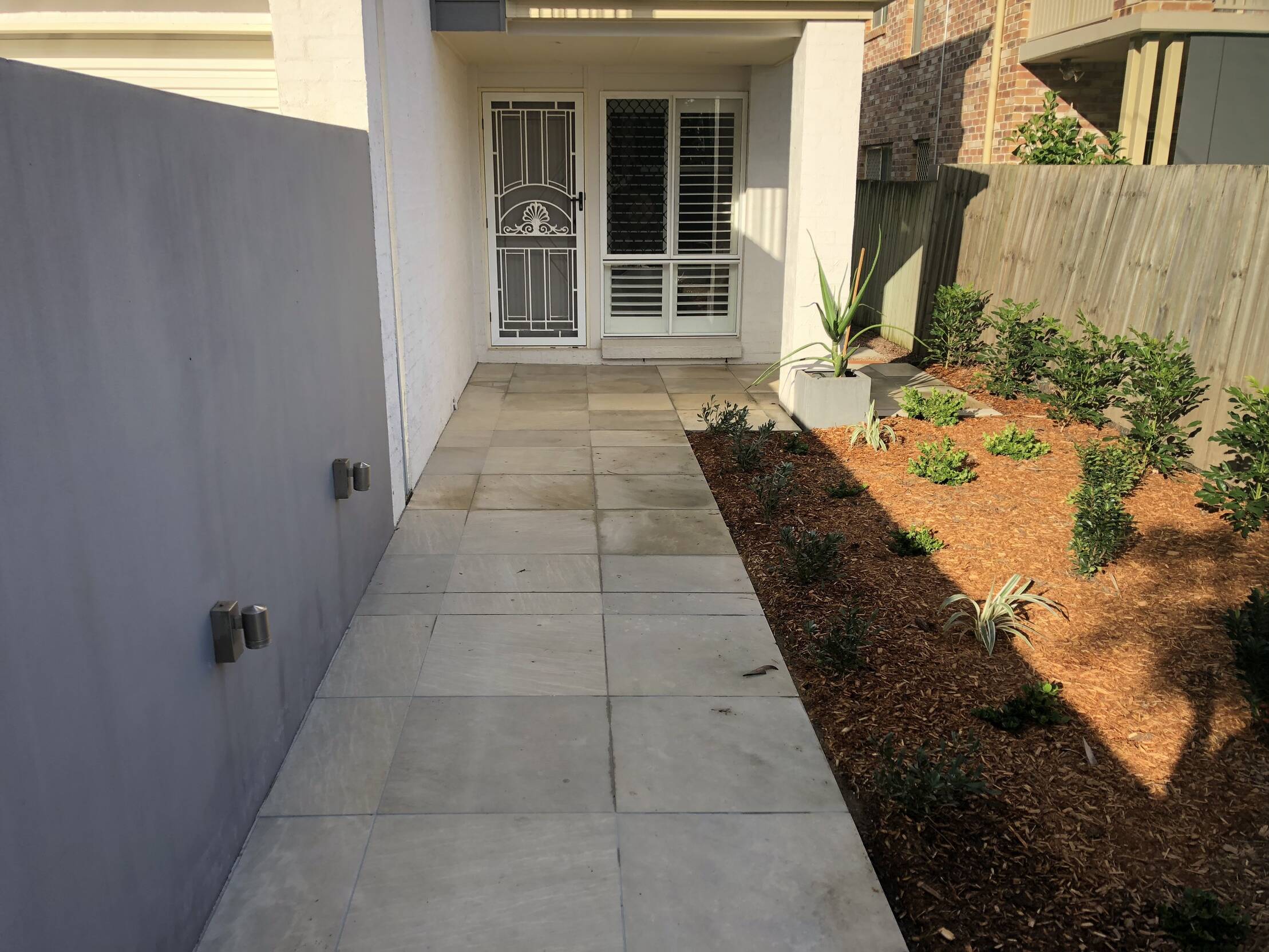 Path leading to the entrance of a residential property, after professional cleaning