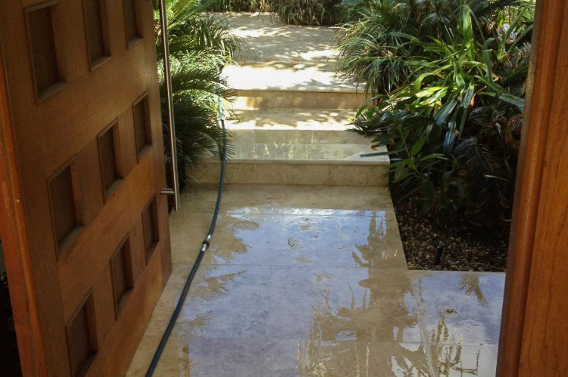 Wet concrete pathway and steps after a professional clean