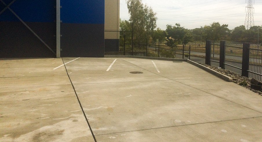 Photo showing a concrete car park ready for cleaning