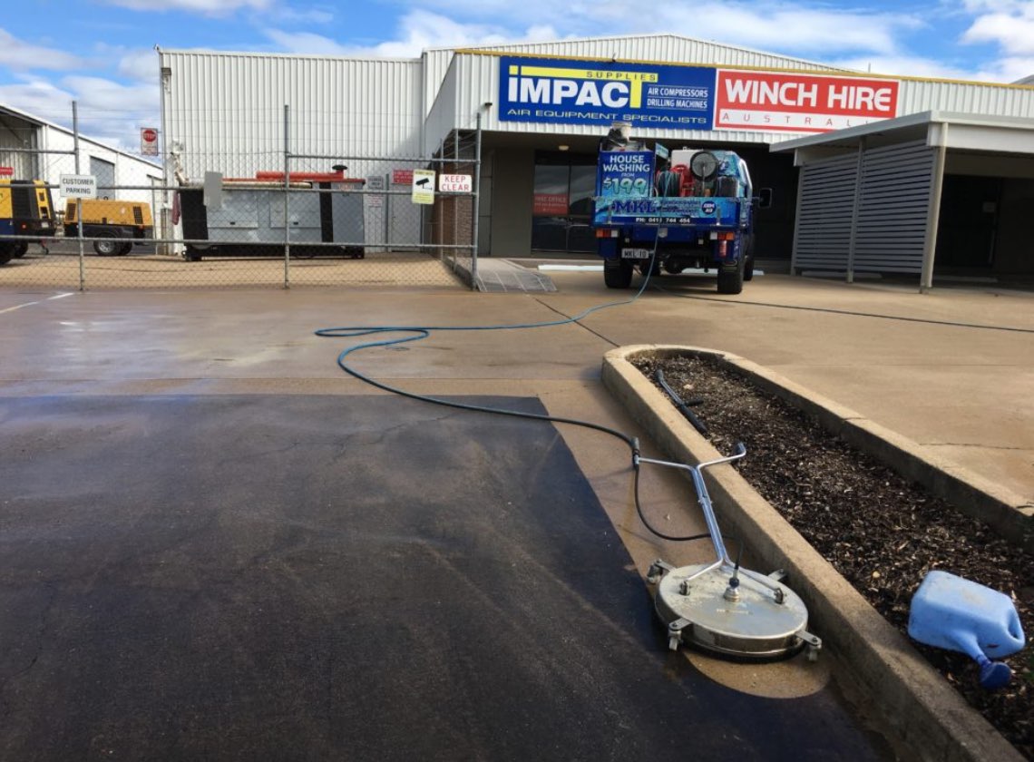 Business driveway being cleaned by a professional machine