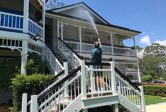 Man washing a house in Brisbane