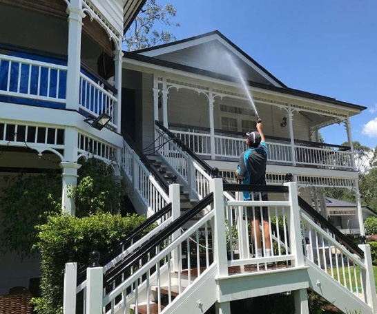 Man washing a house in Brisbane