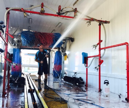 Man washing the inside of a carwash