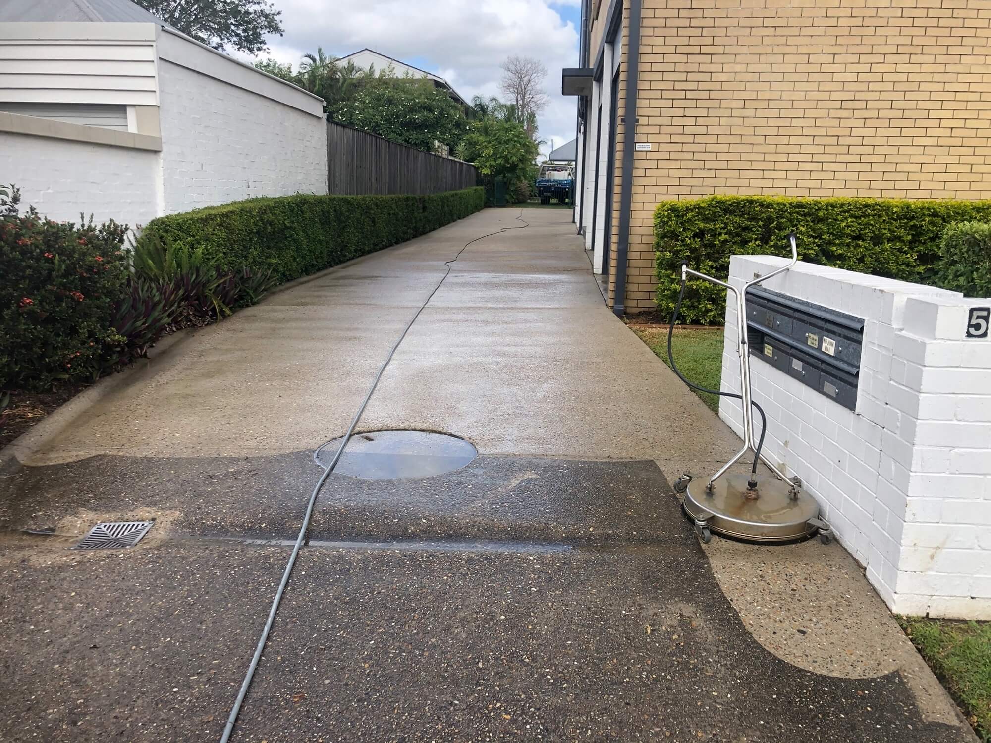 Driveway in Brisbane being cleaned by a machine
