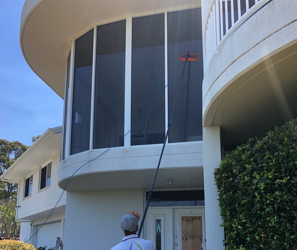 Man washing a grand white house | Featured Image for the House Washing Brisbane Page of MKL Pressure Cleaning.