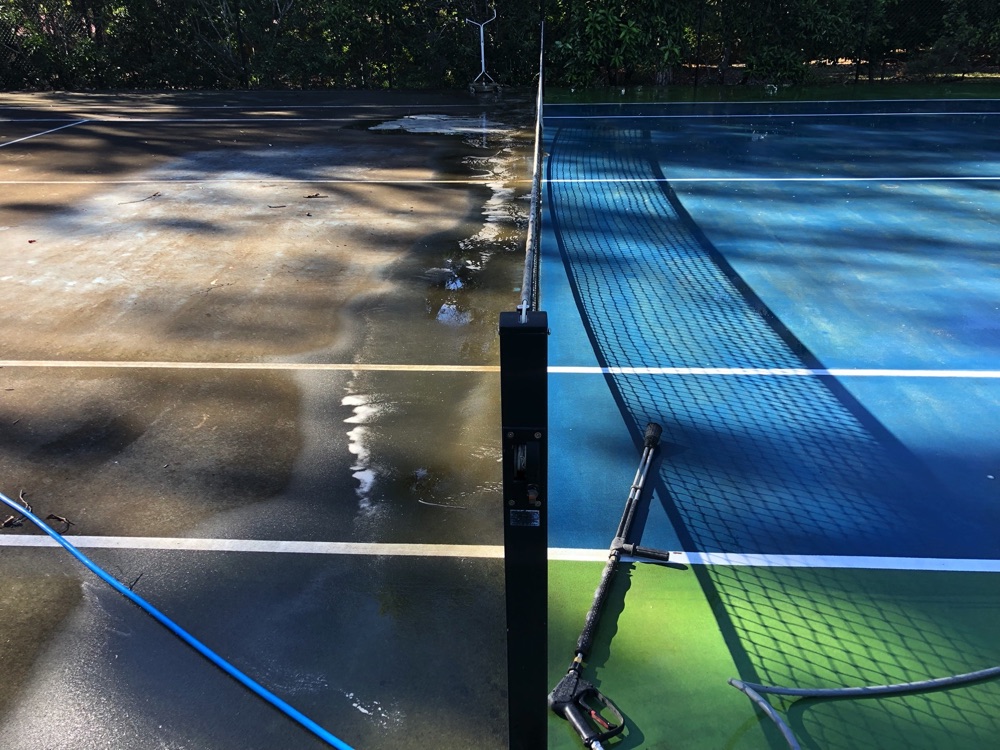 Tennis court cleaning in progress